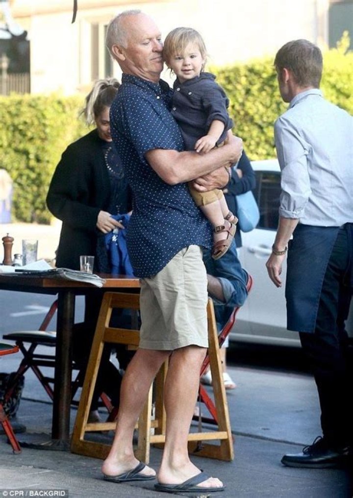 Michael Keaton plays doting grandpa as he cuddles up with adorable